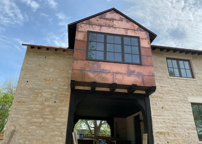Copper metal panel facade on a stone building for Metal Roof Coating in Aurora